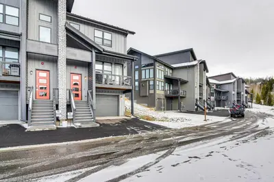 a snowy street in a city with houses at Saltwater Hot Tub! Unit Near Winter Park Slopes in Fraser