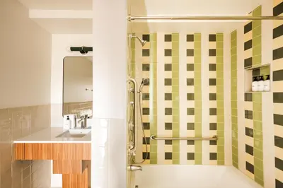 a bathroom with a shower and a sink at La Vista Motel in Denver