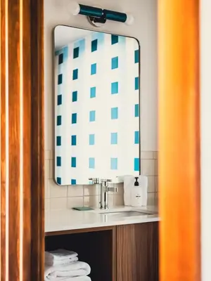 a bathroom with a sink and a mirror at La Vista Motel in Denver