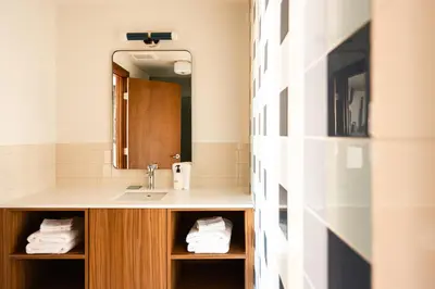 a bathroom with a sink and a mirror at La Vista Motel in Denver