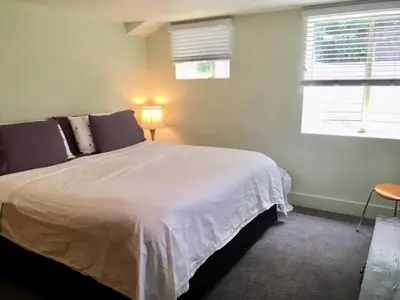 a bedroom with a large white bed with a window at King Suite Between City and Slopes in Denver