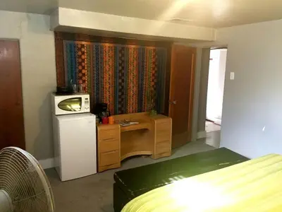 a small room with a refrigerator and a microwave at King Suite Between City and Slopes in Denver