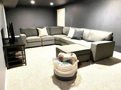 a living room with a couch and a table at Townhome with Dedicated Workspace, WIFI, Garage in Lakewood