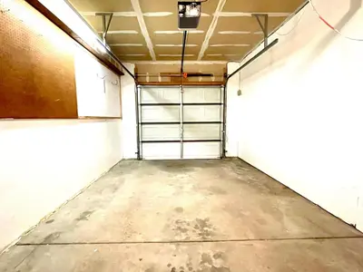 an empty garage with a garage door and a ceiling at Townhome with Dedicated Workspace, WIFI, Garage in Lakewood