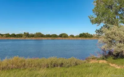 a large body of water with trees and grass at Townhome with Dedicated Workspace, WIFI, Garage in Lakewood