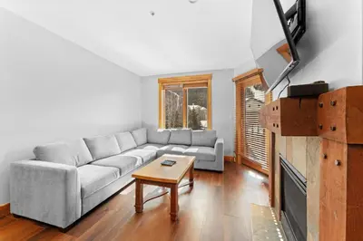 a living room with a couch and a table at Springs Unit 8865 in Keystone