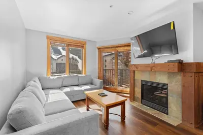 a living room with a couch and a fireplace at Springs Unit 8865 in Keystone
