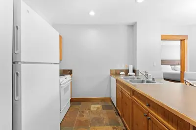 a kitchen with a white refrigerator and a sink at Springs Unit 8865 in Keystone