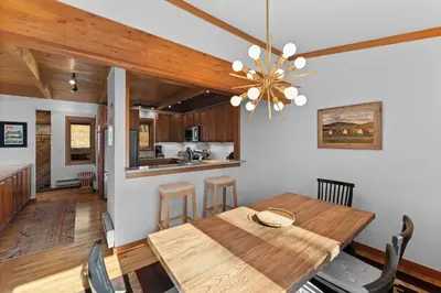 a dining room and kitchen with a wooden table at Tennis Townhome Unit 1321 in Keystone