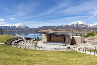 a rendering of a building with mountains in the background at Snowdance 204A in Keystone