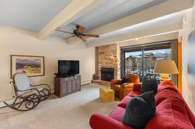 a living room with a red couch and a tv at The Lodge at Lake Dillon 308 in Dillon