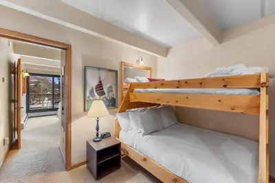 a bedroom with two bunk beds and a lamp at The Lodge at Lake Dillon 308 in Dillon
