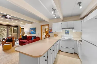 a kitchen with a counter top and a living room at The Lodge at Lake Dillon 308 in Dillon