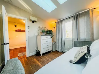 a bedroom with a bed and a dresser and a window at 9 Min Walk to Pearl Street - Downtown Boulder in Boulder