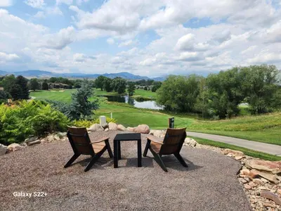 a table and two chairs with a view of a river at Scenic Golf Course Retreat near CSU & Estes Park! in Loveland