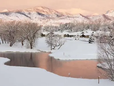 a winter scene of a river with snow and mountains at Scenic Golf Course Retreat near CSU & Estes Park! in Loveland