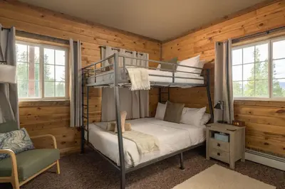 a bedroom with bunk beds in a log cabin at The Moose Hoose Cabin With Views and Game Room in Black Hawk