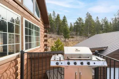 a grill on the balcony of a house at The Moose Hoose Cabin With Views and Game Room in Black Hawk