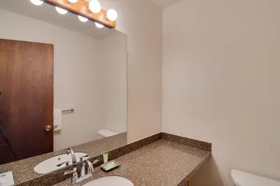 a bathroom with a sink and a mirror at Shuttle to Winter Park Resort! Group Condo with Pool in Winter Park