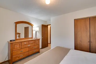 a bedroom with a dresser and a mirror at Ski, Soak and Chill! Pool-View Winter Park Condo in Winter Park