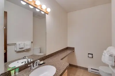 a bathroom with a sink and a mirror at Ski, Soak and Chill! Pool-View Winter Park Condo in Winter Park