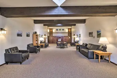 a large living room with couches and tables at Ski, Soak and Chill! Pool-View Winter Park Condo in Winter Park