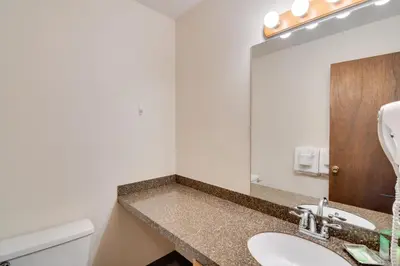 a bathroom with a sink and a mirror at 3 Mi to Skiing Walkable Dtwn Winter Park Condo! in Winter Park