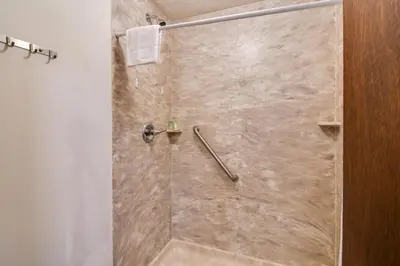 a bathroom with a shower with a glass door at 3 Mi to Skiing Walkable Dtwn Winter Park Condo! in Winter Park