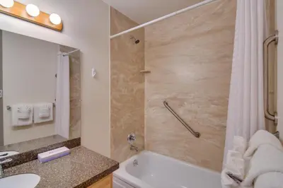 a bathroom with a shower and a toilet and a sink at 3 Mi to Skiing Walkable Dtwn Winter Park Condo! in Winter Park