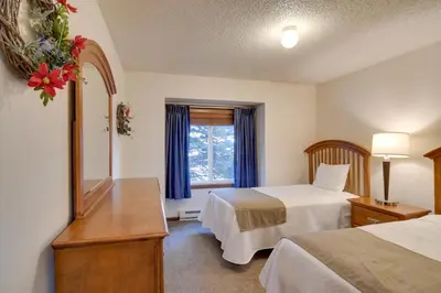 a hotel room with two beds and a mirror at Hot Tub and Heated Pool! Ski Retreat in Winter Park in Winter Park