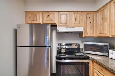 a kitchen with a stainless steel refrigerator and a stove at Hot Tub and Heated Pool! Ski Retreat in Winter Park in Winter Park