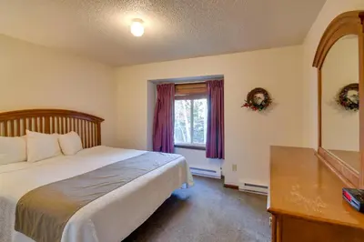 a bedroom with a bed and a mirror and a window at Hot Tub and Heated Pool! Ski Retreat in Winter Park in Winter Park