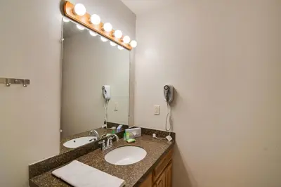 a bathroom with a sink and a large mirror at Hot Tub and Heated Pool! Ski Retreat in Winter Park in Winter Park