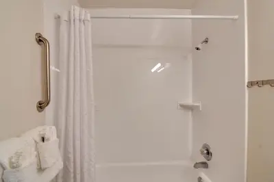 a shower with a white shower curtain in a bathroom at Hot Tub and Heated Pool! Ski Retreat in Winter Park in Winter Park
