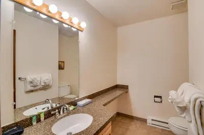 a bathroom with a sink and a large mirror at Hot Tub and Heated Pool! Ski Retreat in Winter Park in Winter Park