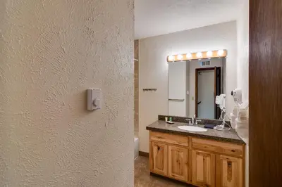 a bathroom with a sink and a mirror at Ski and Hike! Easy Adventuring at Winter Park Condo in Winter Park