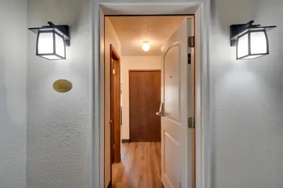 a hallway with two lights on the walls at Ski and Hike! Easy Adventuring at Winter Park Condo in Winter Park