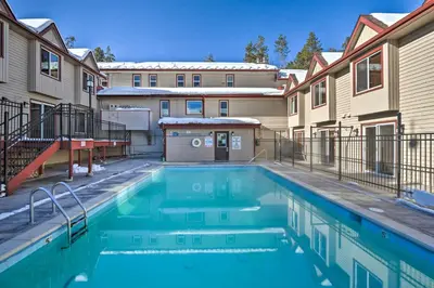 a swimming pool in the courtyard of a apartment building at Ski and Hike! Easy Adventuring at Winter Park Condo in Winter Park
