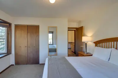 a bedroom with a large bed with a wooden headboard at Walk to Ski Shuttle! Ideal Winter Park Base Camp in Winter Park