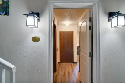 a hallway with two lights on the wall and a door at Walk to Ski Shuttle! Ideal Winter Park Base Camp in Winter Park