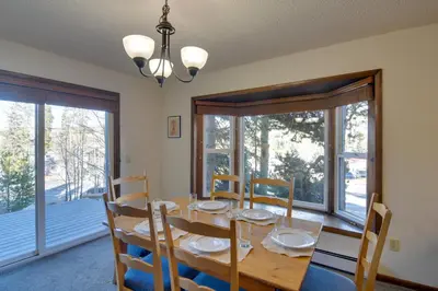 a dining room with a table and chairs and windows at Walk to Ski Shuttle! Ideal Winter Park Base Camp in Winter Park
