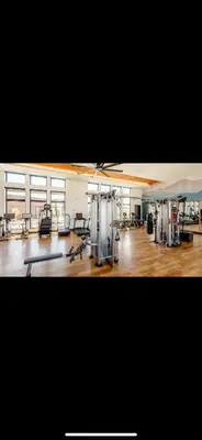 a gym with several treadmills and machines in a room at Elegant Stay in Aurora