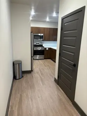 an empty room with a door and a kitchen at Elegant Stay in Aurora