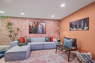 a living room with a blue couch and a chair at Outdoor Movie - Pingpong & Volleyball - Cozy 5BD in Denver