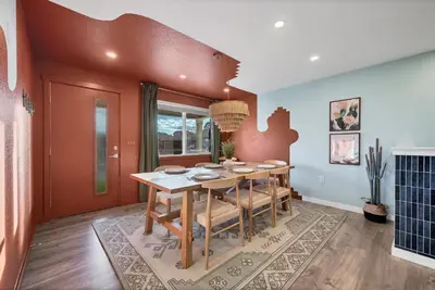 a dining room with a table and chairs at Outdoor Movie - Pingpong & Volleyball - Cozy 5BD in Denver