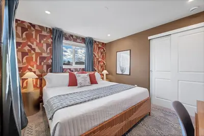 a bedroom with a large bed and a window at Outdoor Movie - Pingpong & Volleyball - Cozy 5BD in Denver