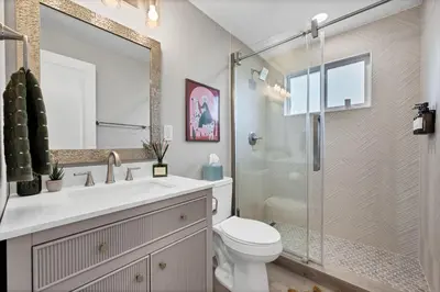 a bathroom with a sink and a toilet and a shower at Outdoor Movie - Pingpong & Volleyball - Cozy 5BD in Denver