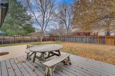 a wooden picnic table sitting on a wooden deck at 4 Mi to TPC Colorado Dog-Friendly Gem in Berthoud in Berthoud