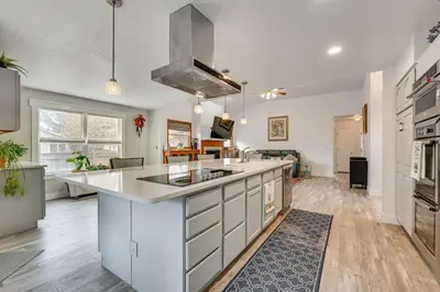 a kitchen with white cabinets and a large island at 4 Mi to TPC Colorado Dog-Friendly Gem in Berthoud in Berthoud