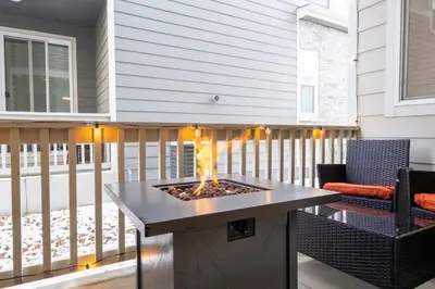 a patio with a fire pit on a deck at Sleeps 8, Fire pit, Near DIA & Downtown Denver in Commerce City